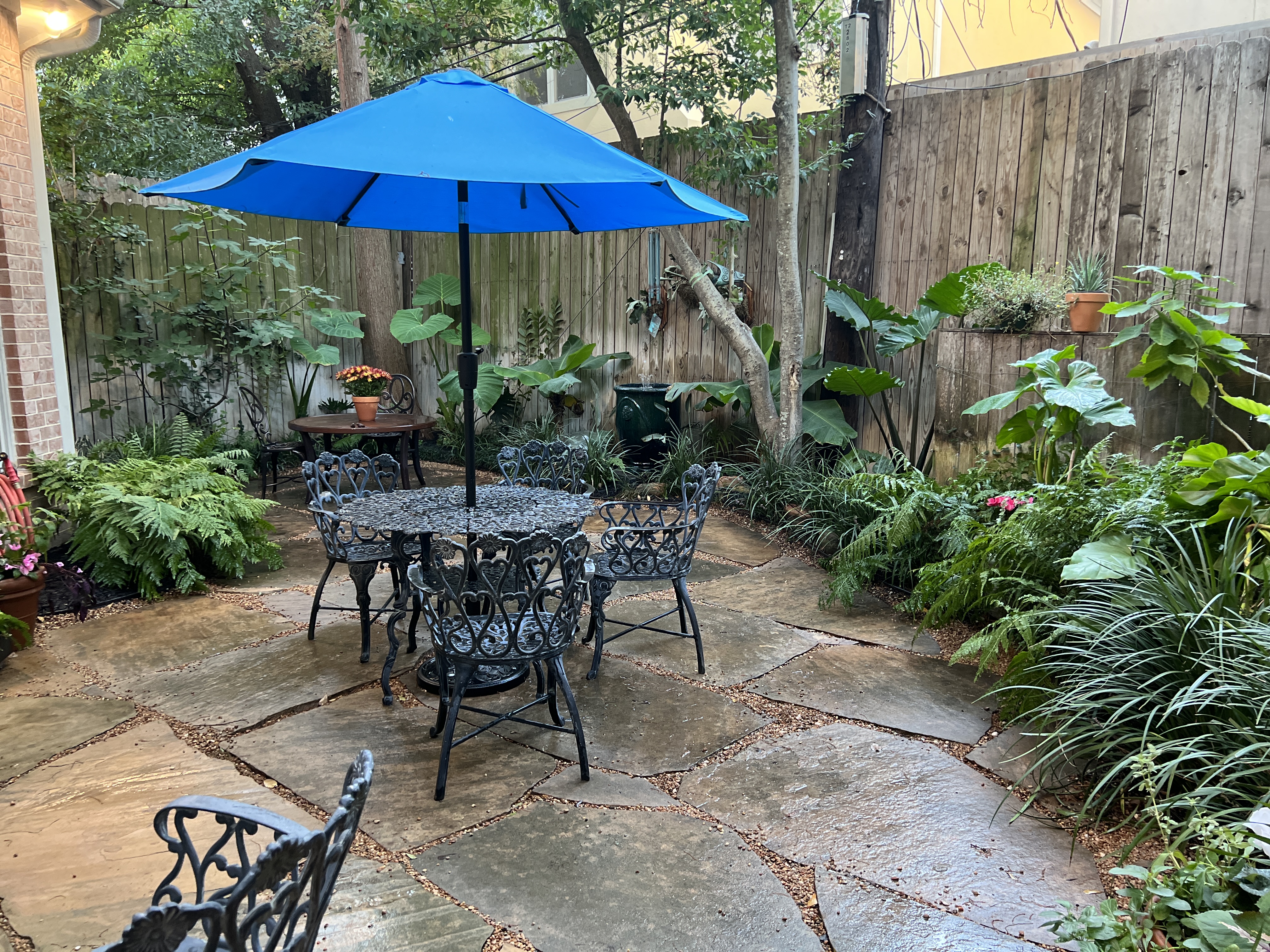 Dramatic front entrance landscape lighting design in Houston Heights neighborhood